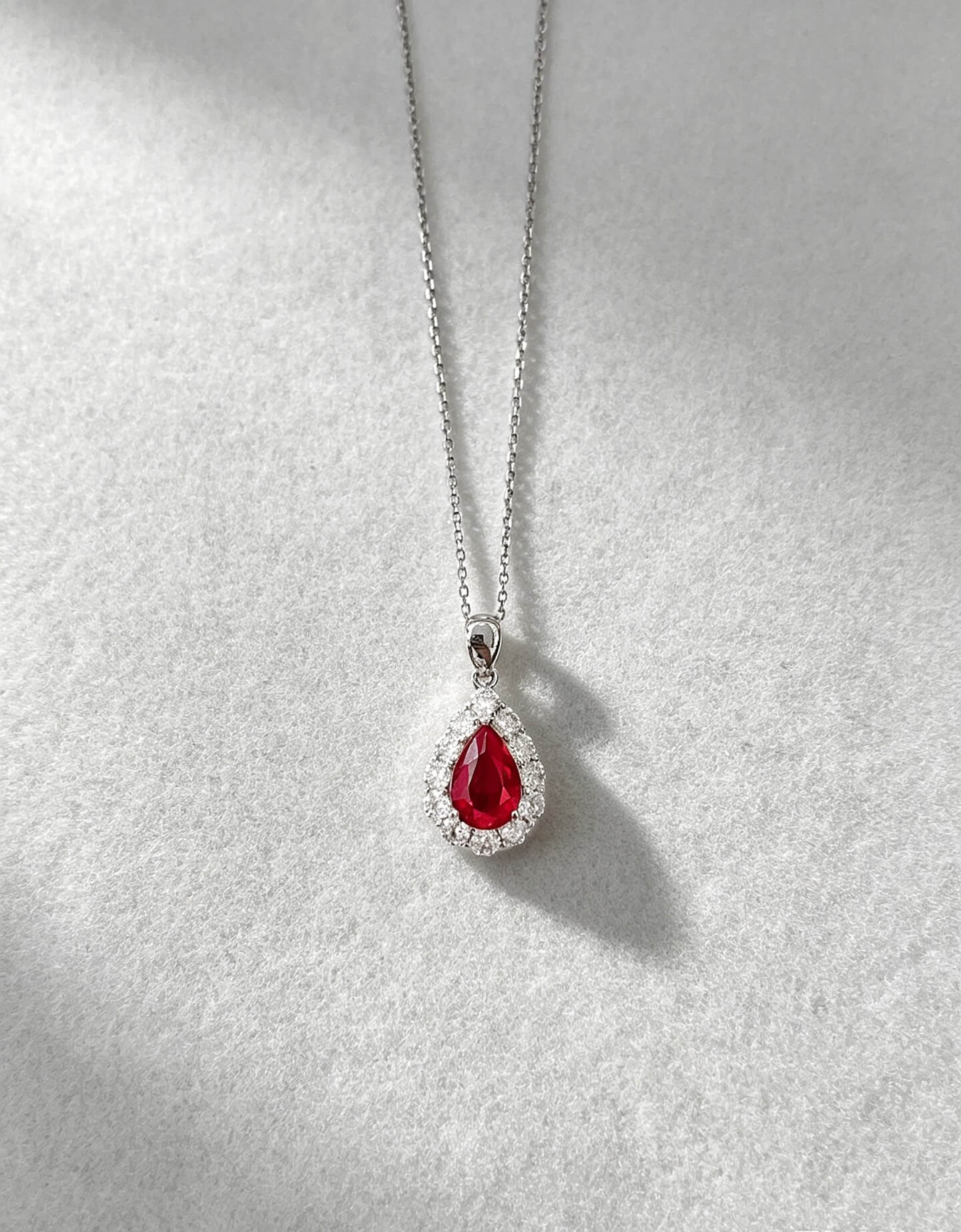 Halo setting pear cut lab grown ruby pendant necklace