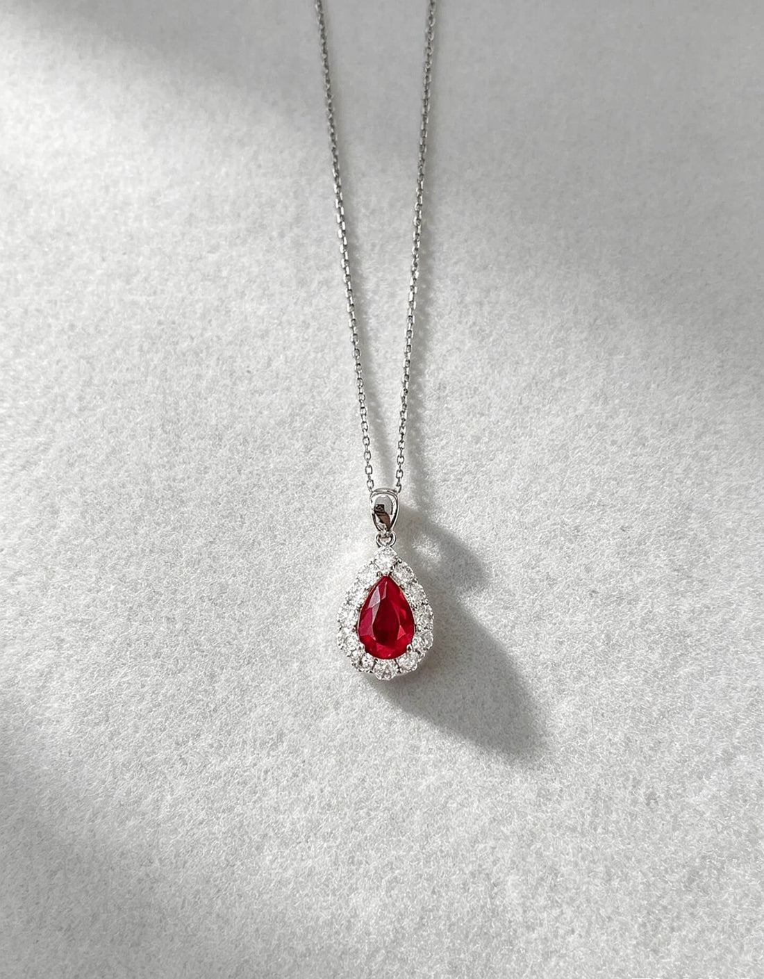 Halo setting pear cut lab grown ruby pendant necklace