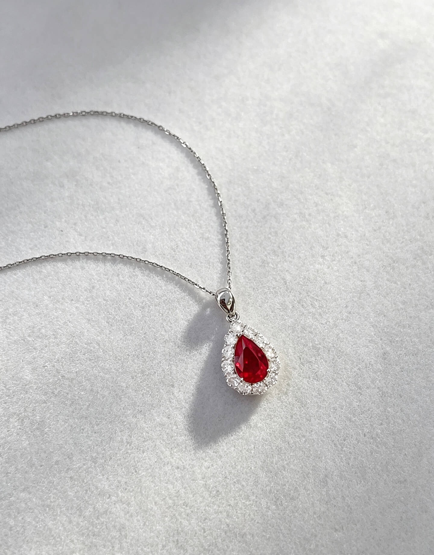 Halo setting pear cut lab grown ruby pendant necklace