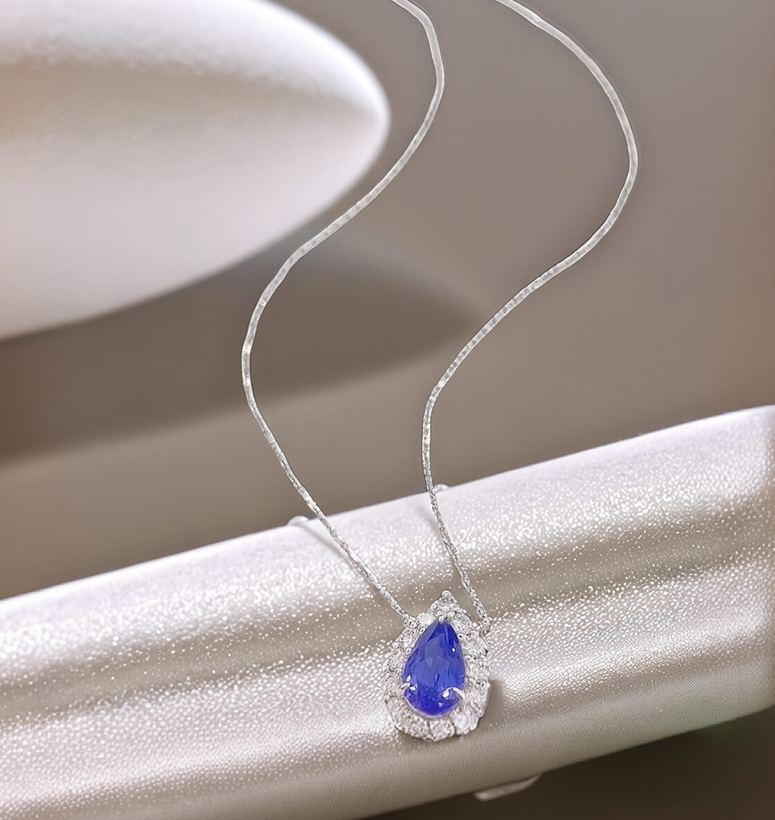 Halo setting pear cut lab grown sapphire pendant necklace