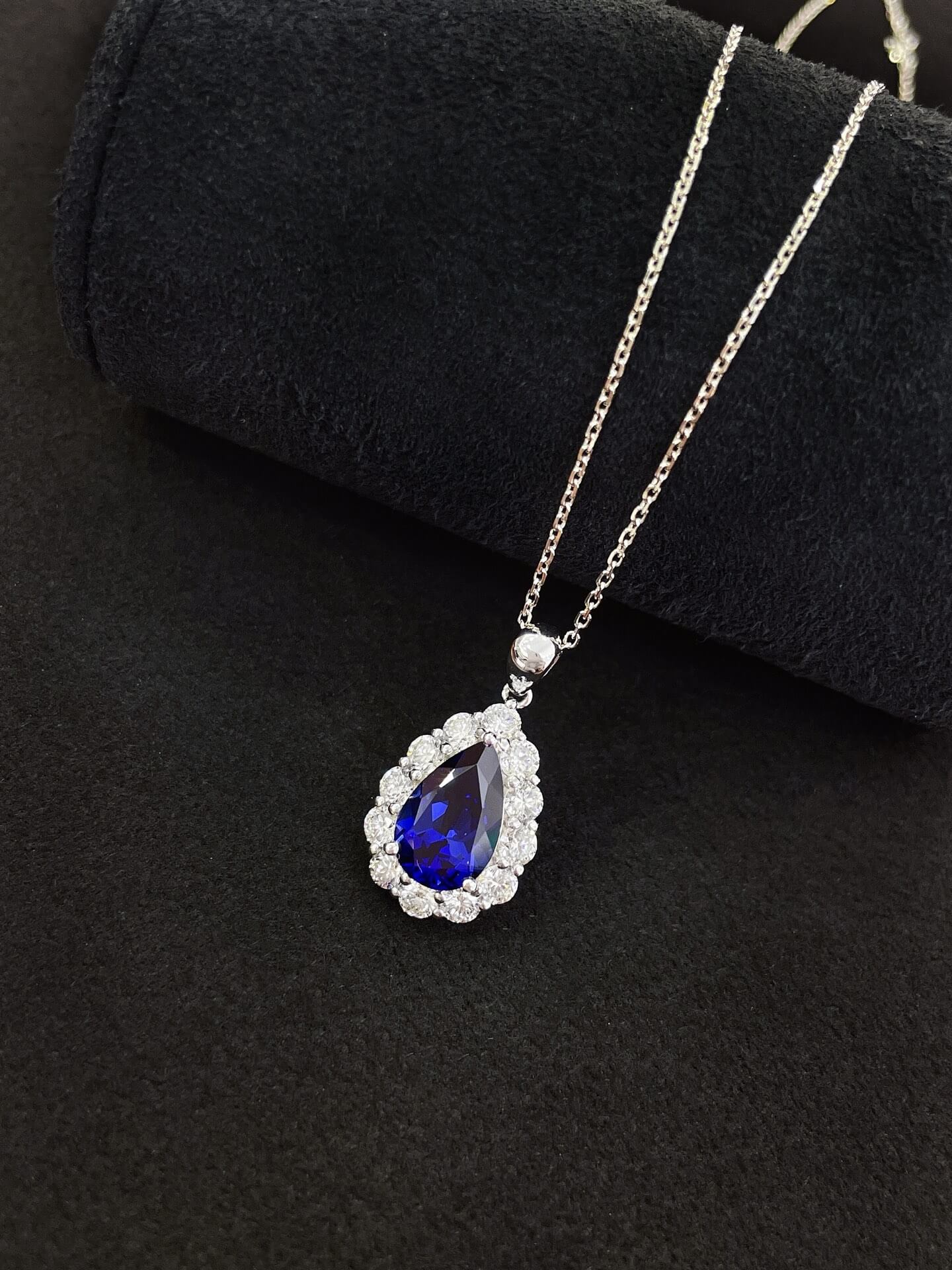 Halo setting pear cut lab grown sapphire pendant necklace