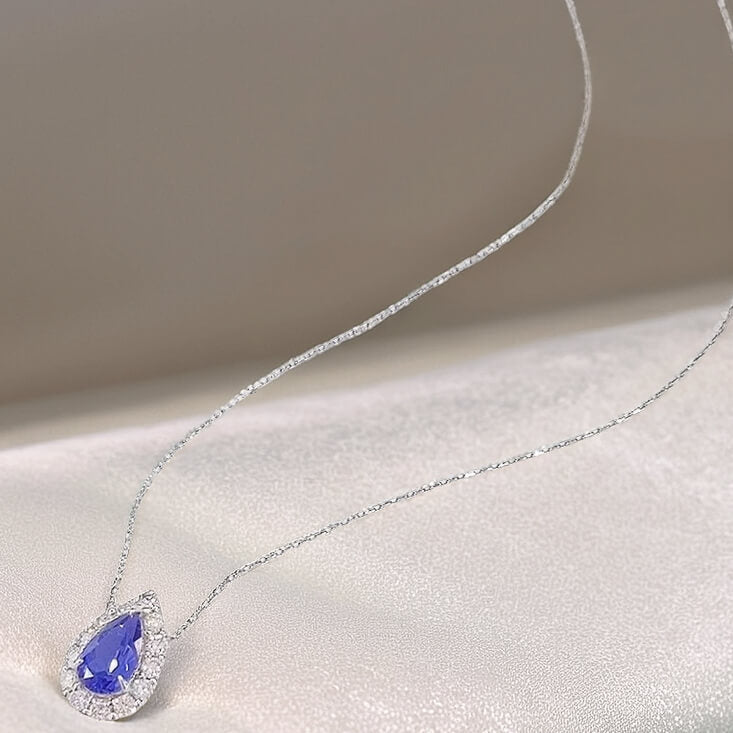 Halo setting pear cut lab grown sapphire pendant necklace