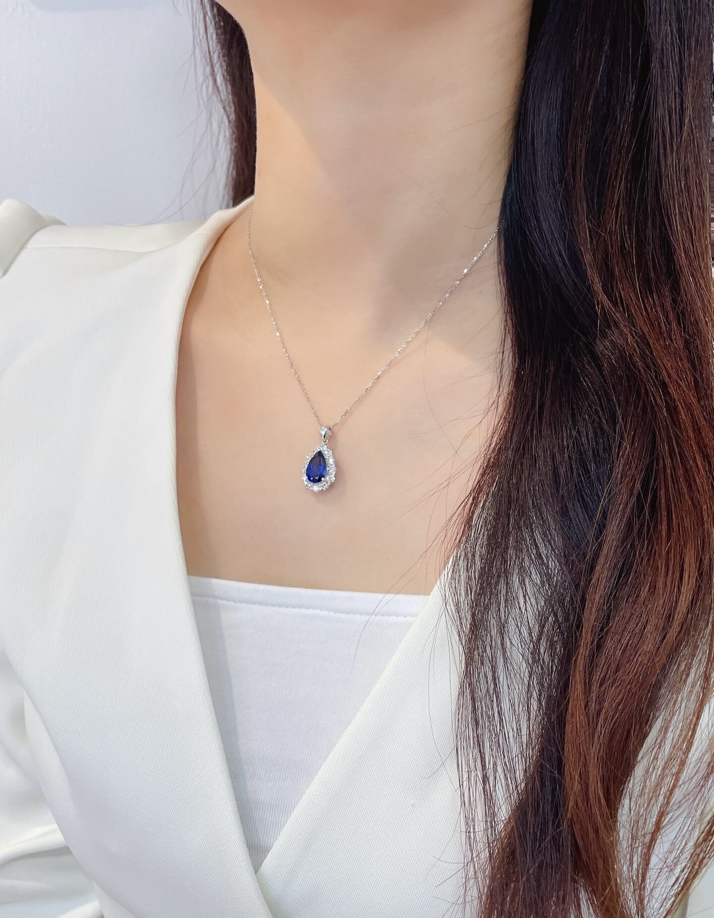 Halo setting pear cut lab grown sapphire pendant necklace