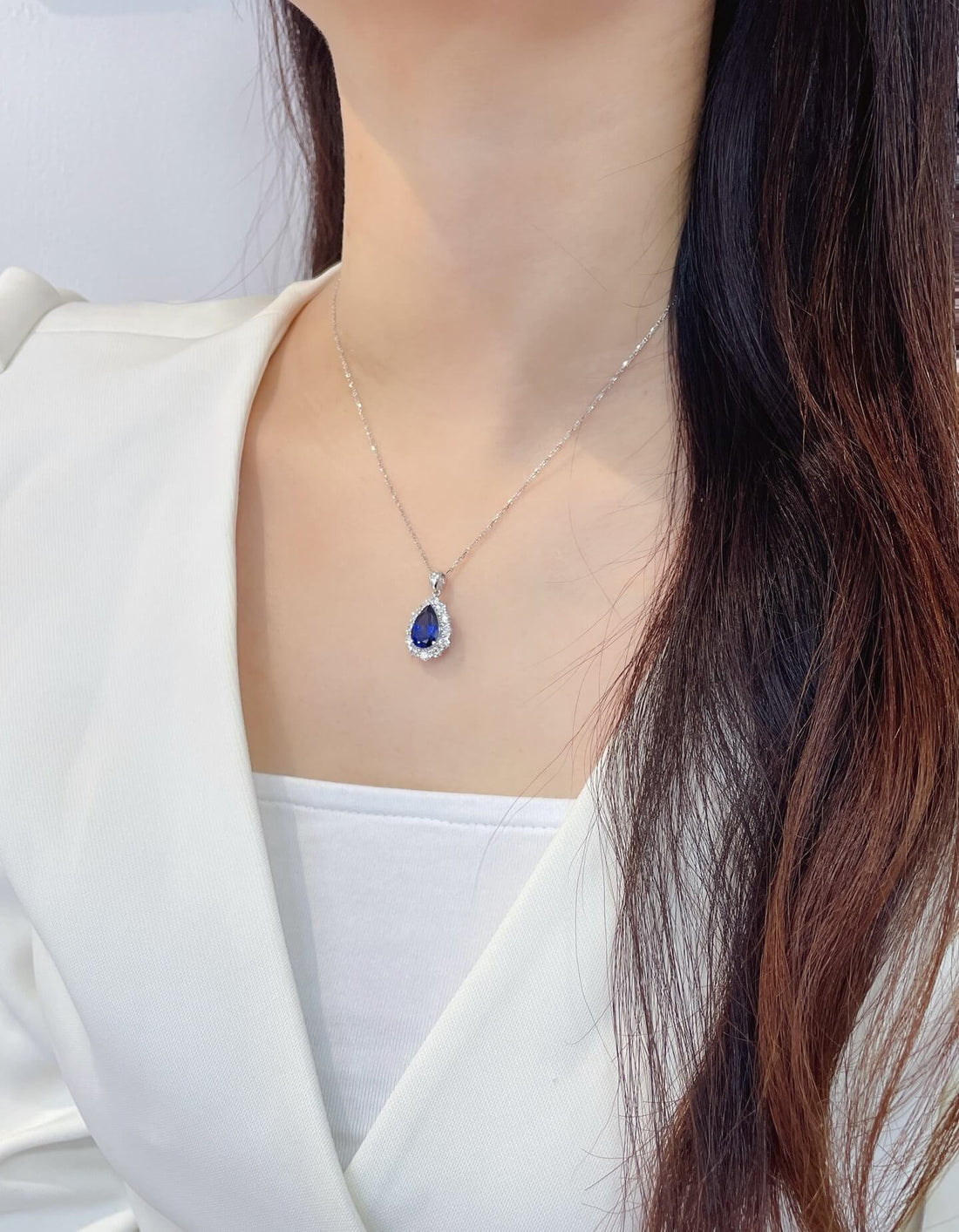 Halo setting pear cut lab grown sapphire pendant necklace