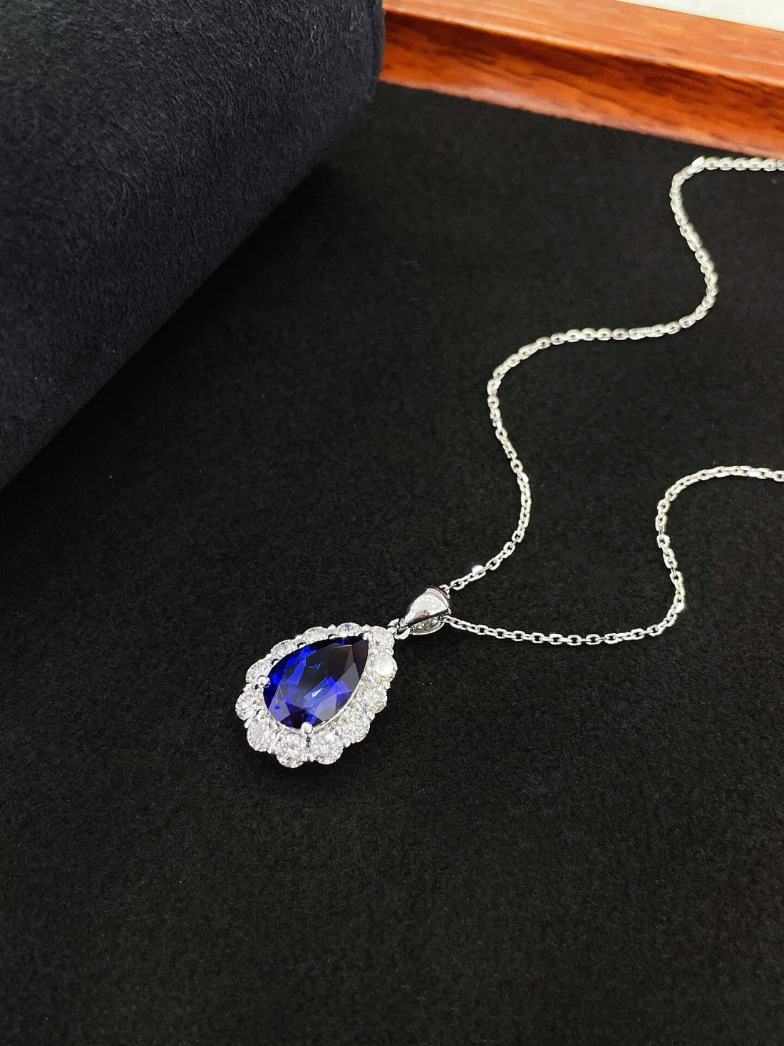 Halo setting pear cut lab grown sapphire pendant necklace