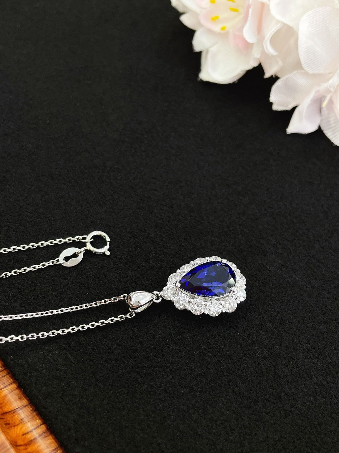Halo setting pear cut lab grown sapphire pendant necklace