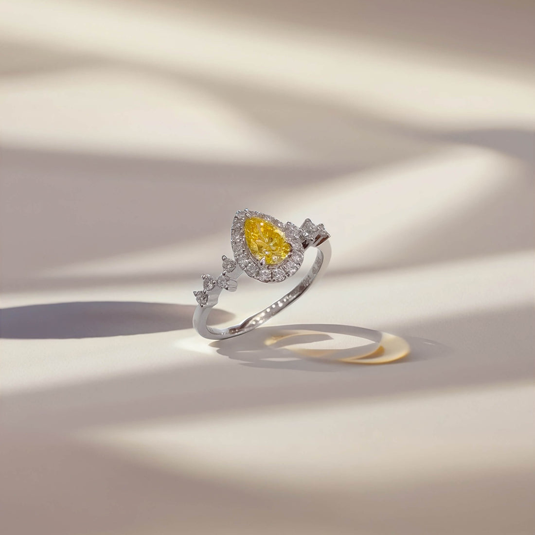 Halo setting pear cut lab grown yellow diamond engagement ring