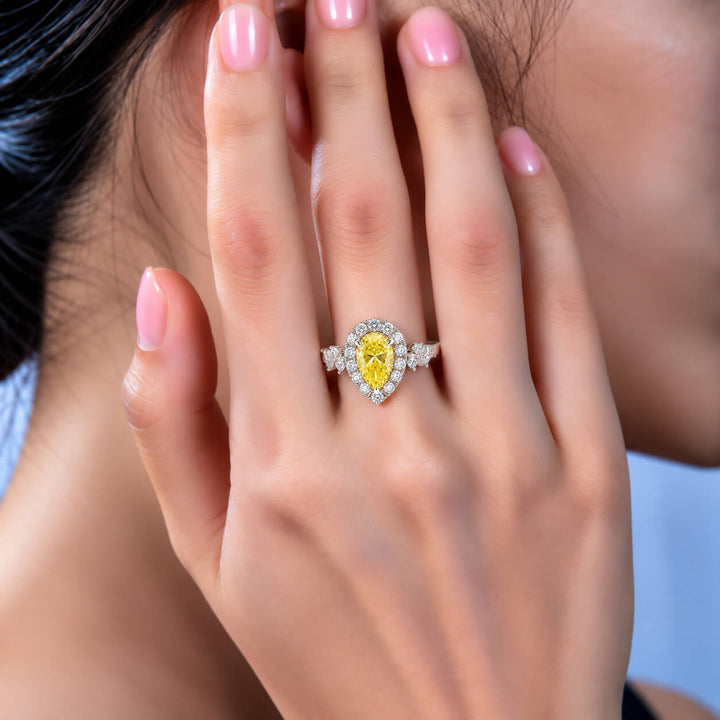 Halo setting pear cut lab grown yellow diamond engagement ring