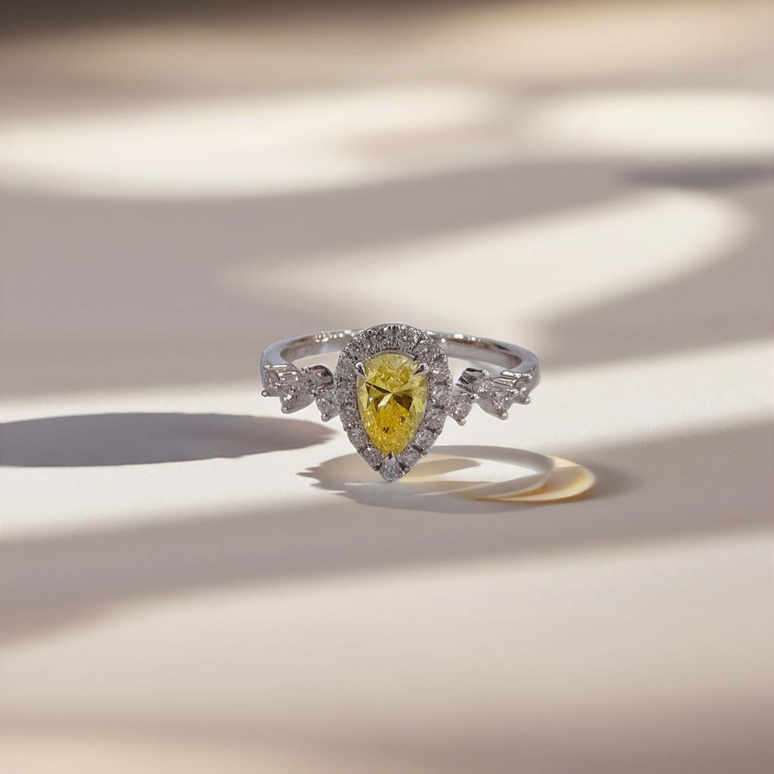 Halo setting pear cut lab grown yellow diamond engagement ring