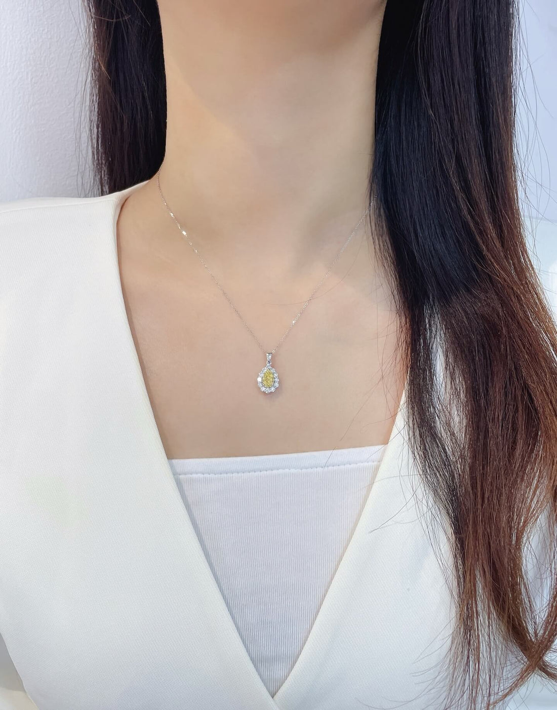 Halo setting pear cut lab grown yellow diamond pendant necklace