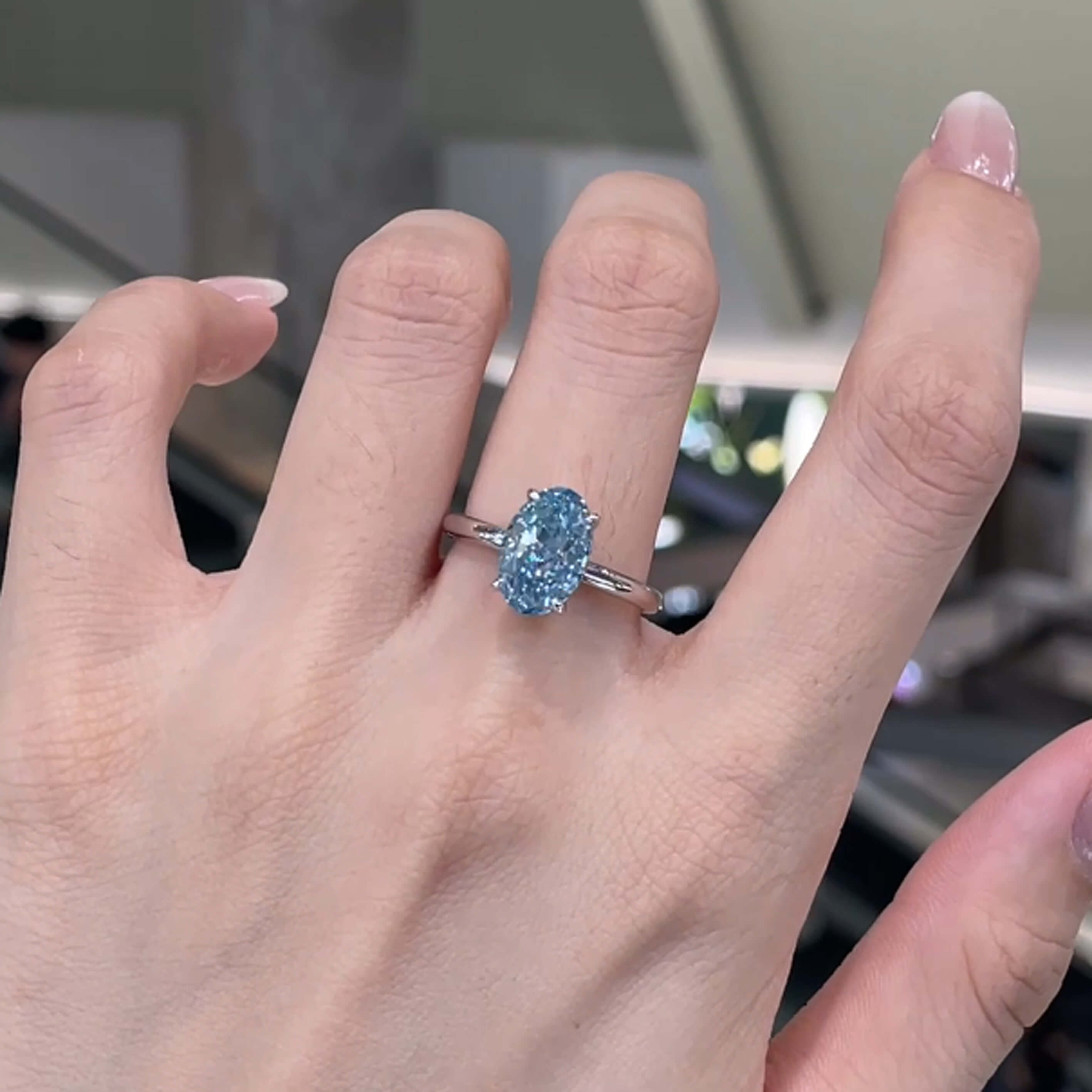Oval cut lab grown blue diamond engagement ring