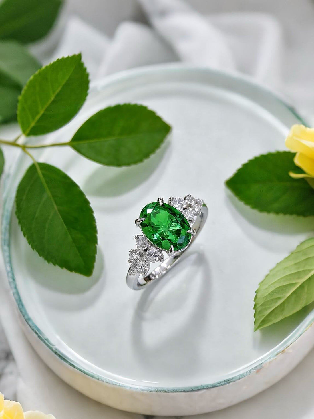 Oval cut lab grown emerald engagement ring