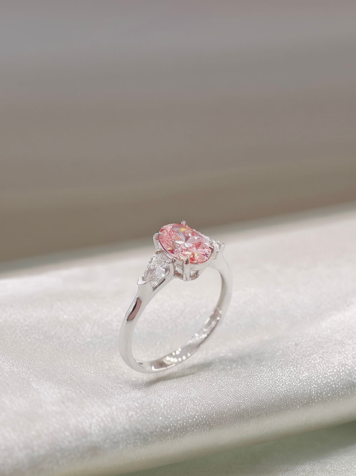 Oval cut lab grown pink diamond three stones engagement ring