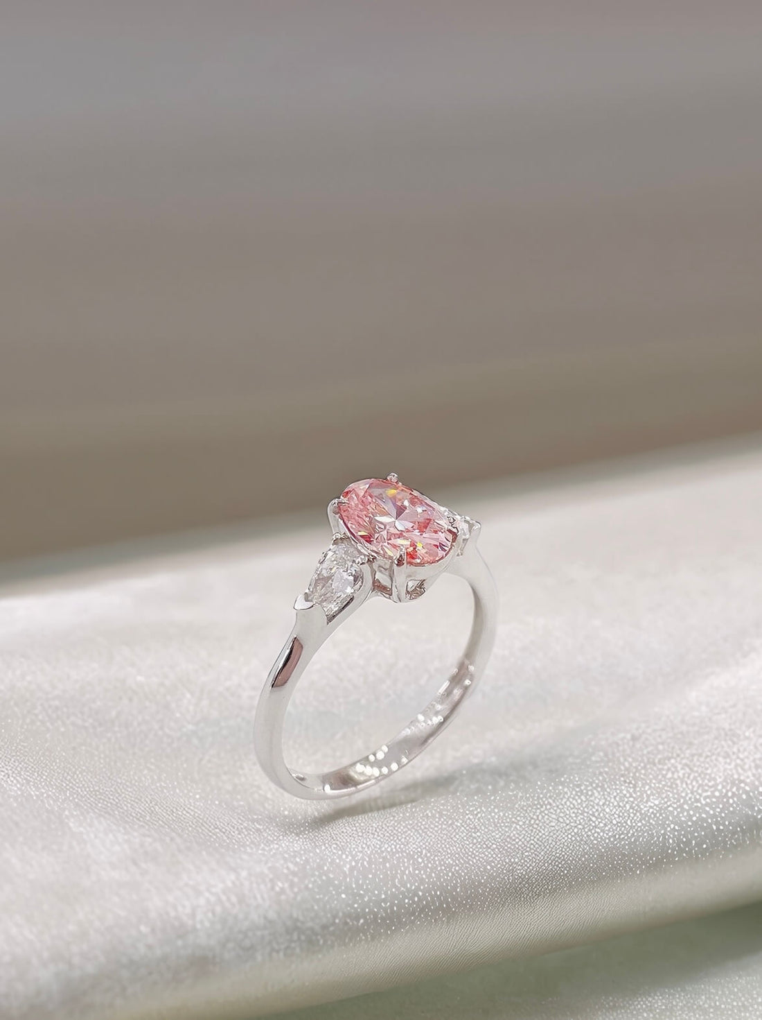 Oval cut lab grown pink diamond three stones engagement ring