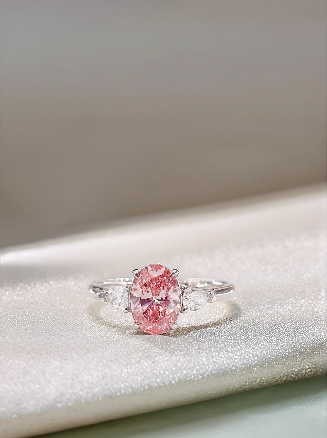 Oval cut lab grown pink diamond three stones engagement ring
