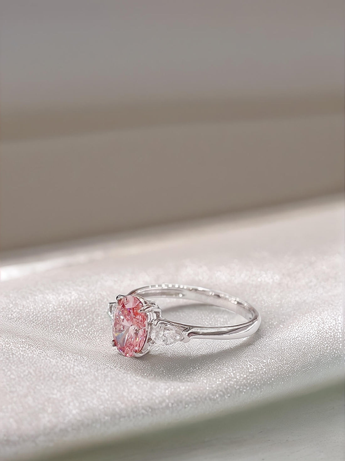 Oval cut lab grown pink diamond three stones engagement ring