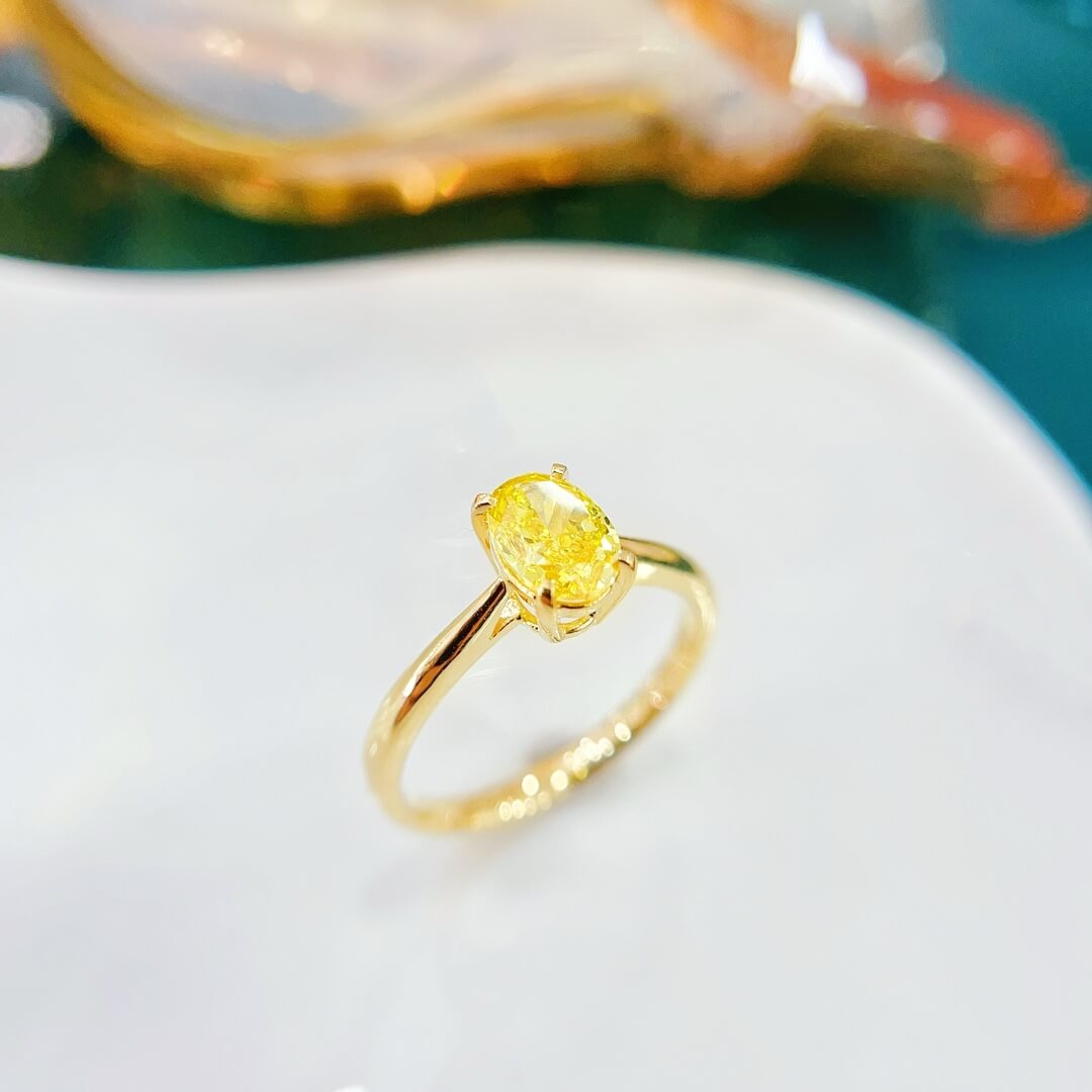 Oval cut lab grown yellow diamond engagement ring