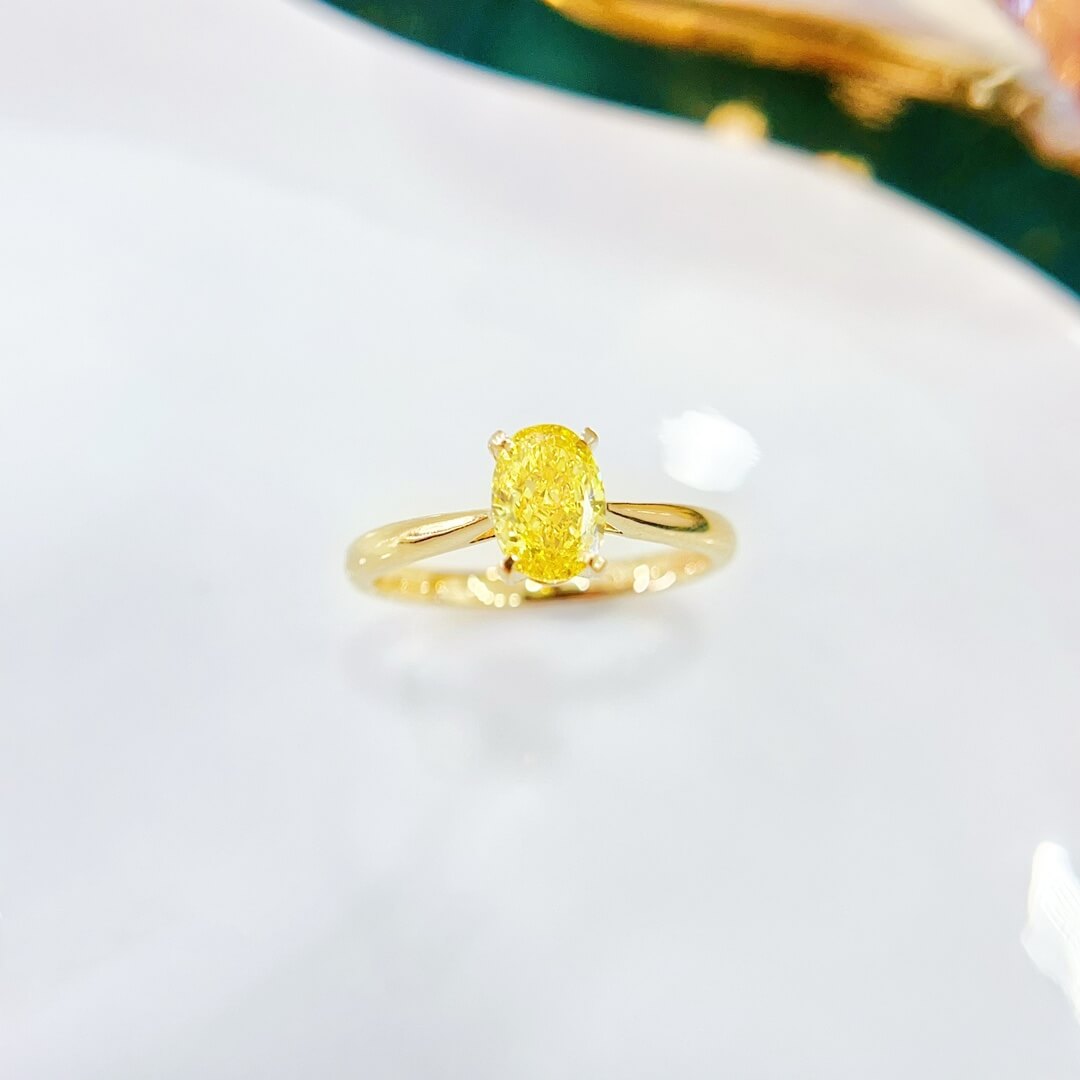 Oval cut lab grown yellow diamond engagement ring