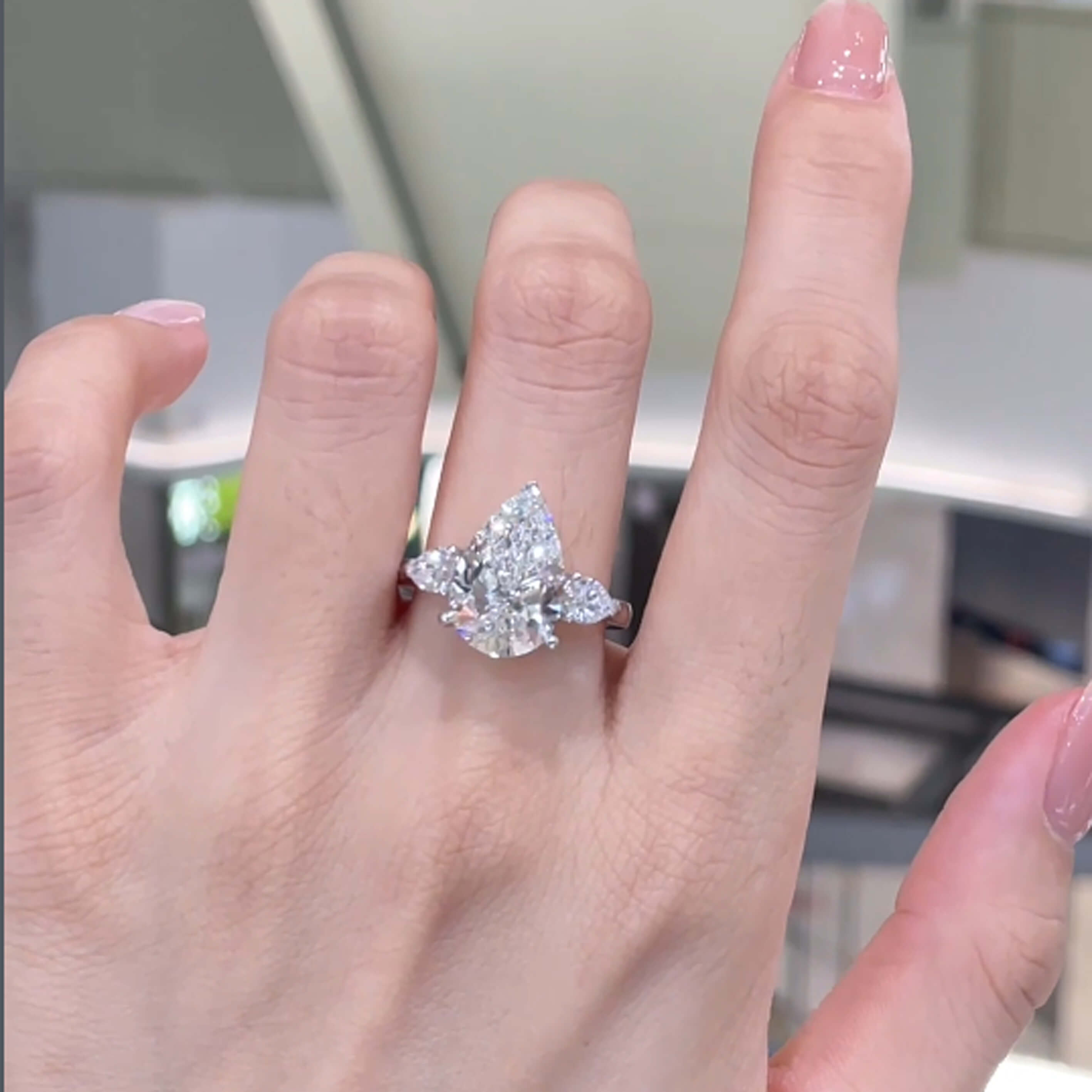 Pear cut lab grown diamond three stones engagement ring