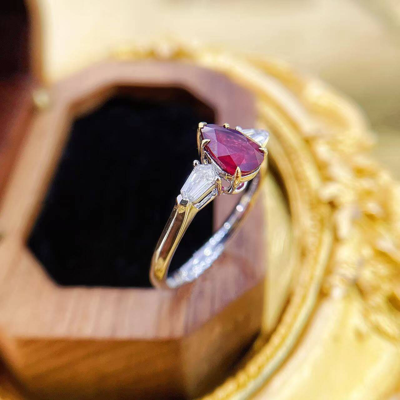 Pear cut lab grown ruby three stones engagement ring