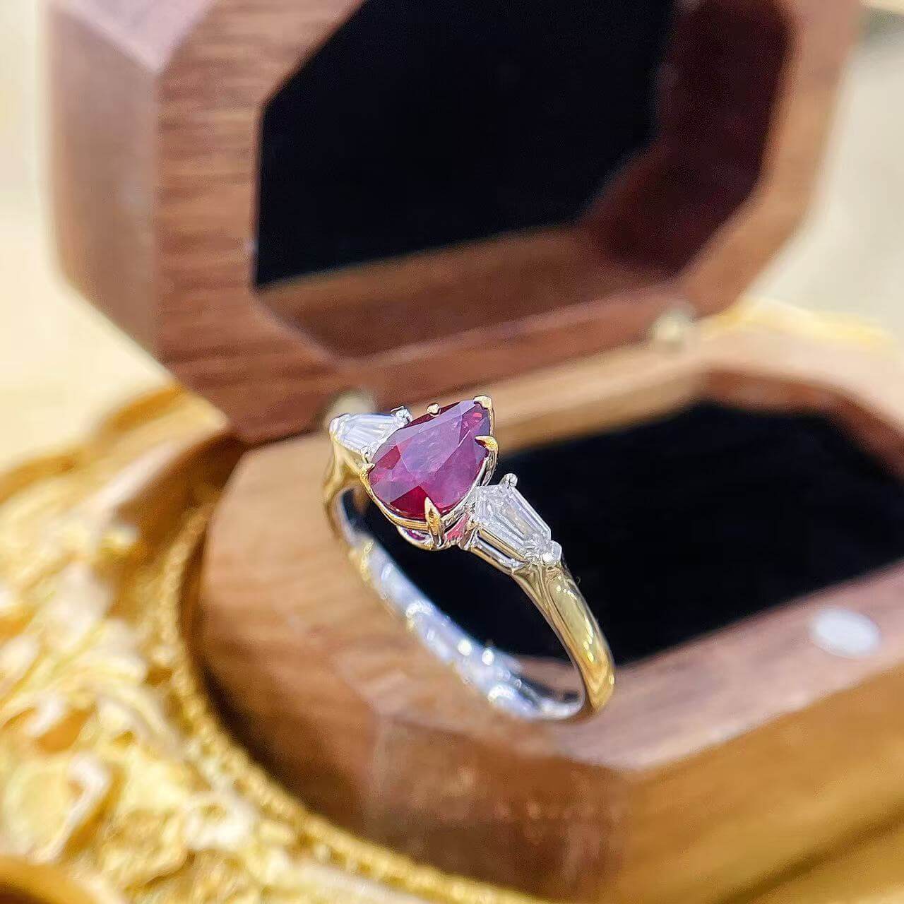 Pear cut lab grown ruby three stones engagement ring