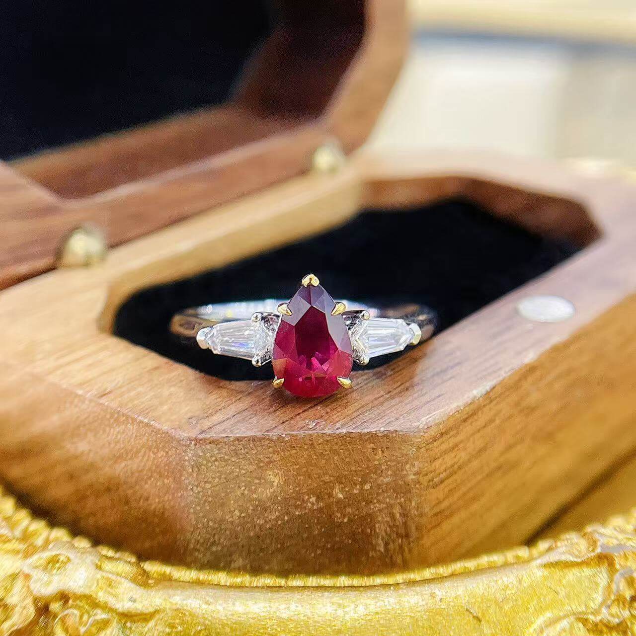 Pear cut lab grown ruby three stones engagement ring