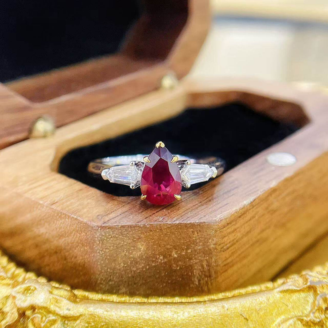 Pear cut lab grown ruby three stones engagement ring