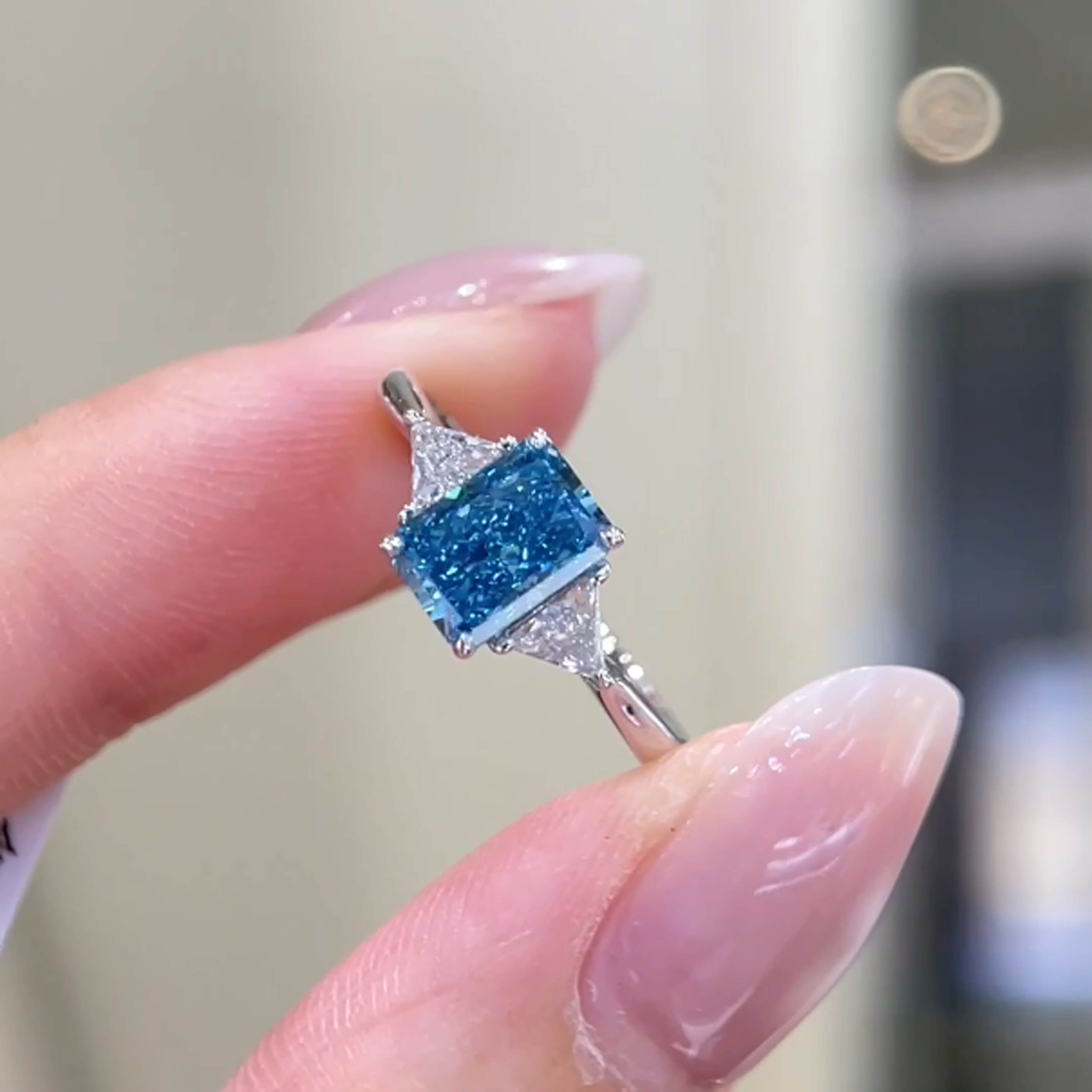 Radiant cut lab grown blue diamond three stones engagement ring