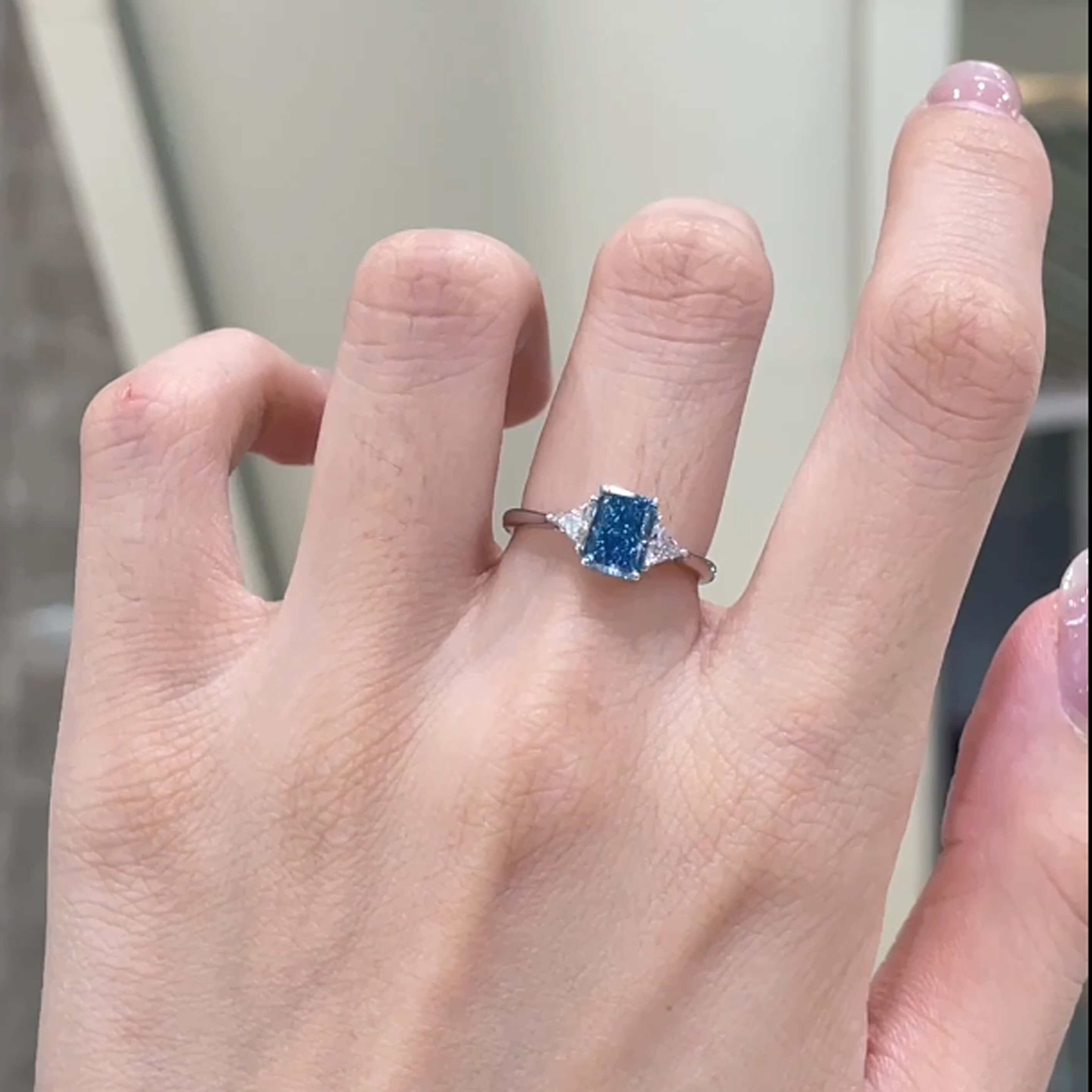 Radiant cut lab grown blue diamond three stones engagement ring
