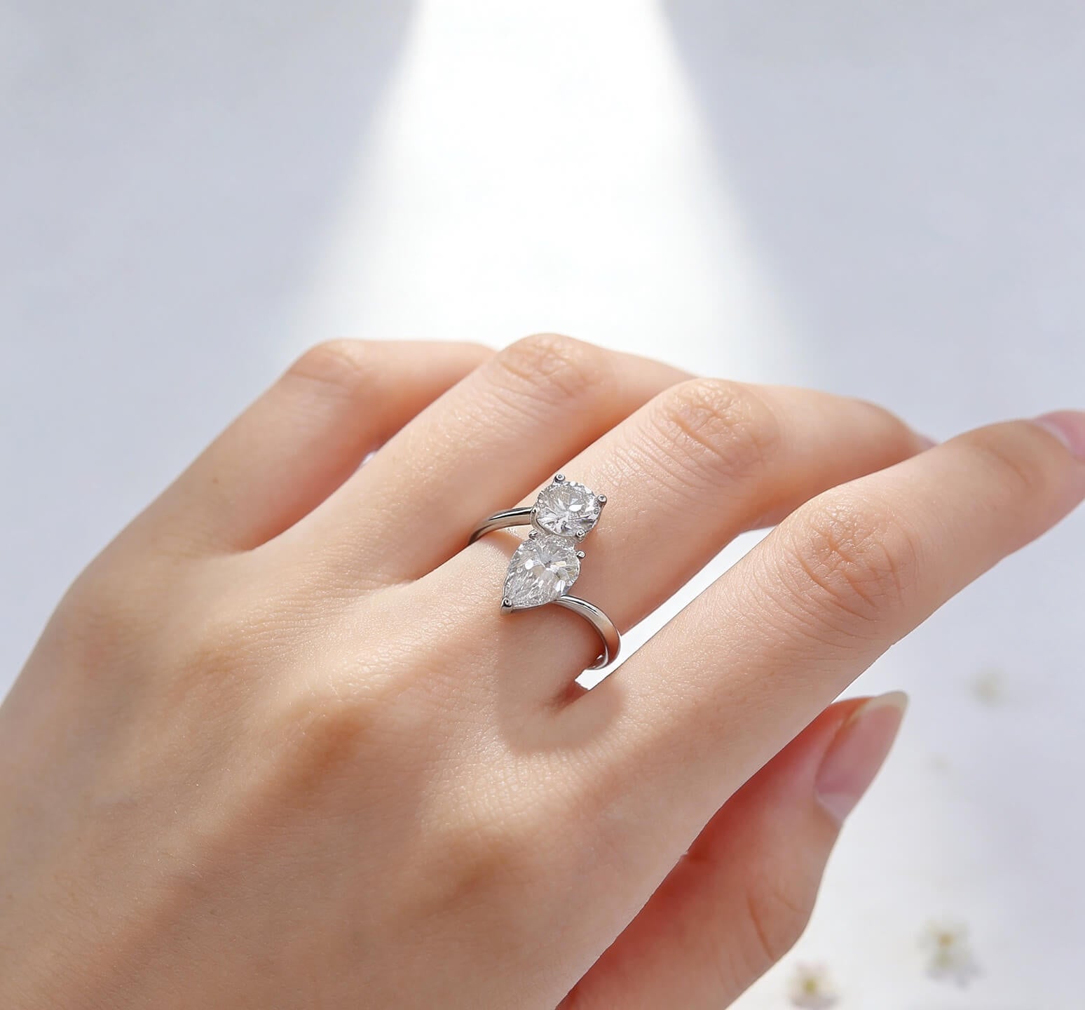 Round and pear cut lab grown diamond engagement ring