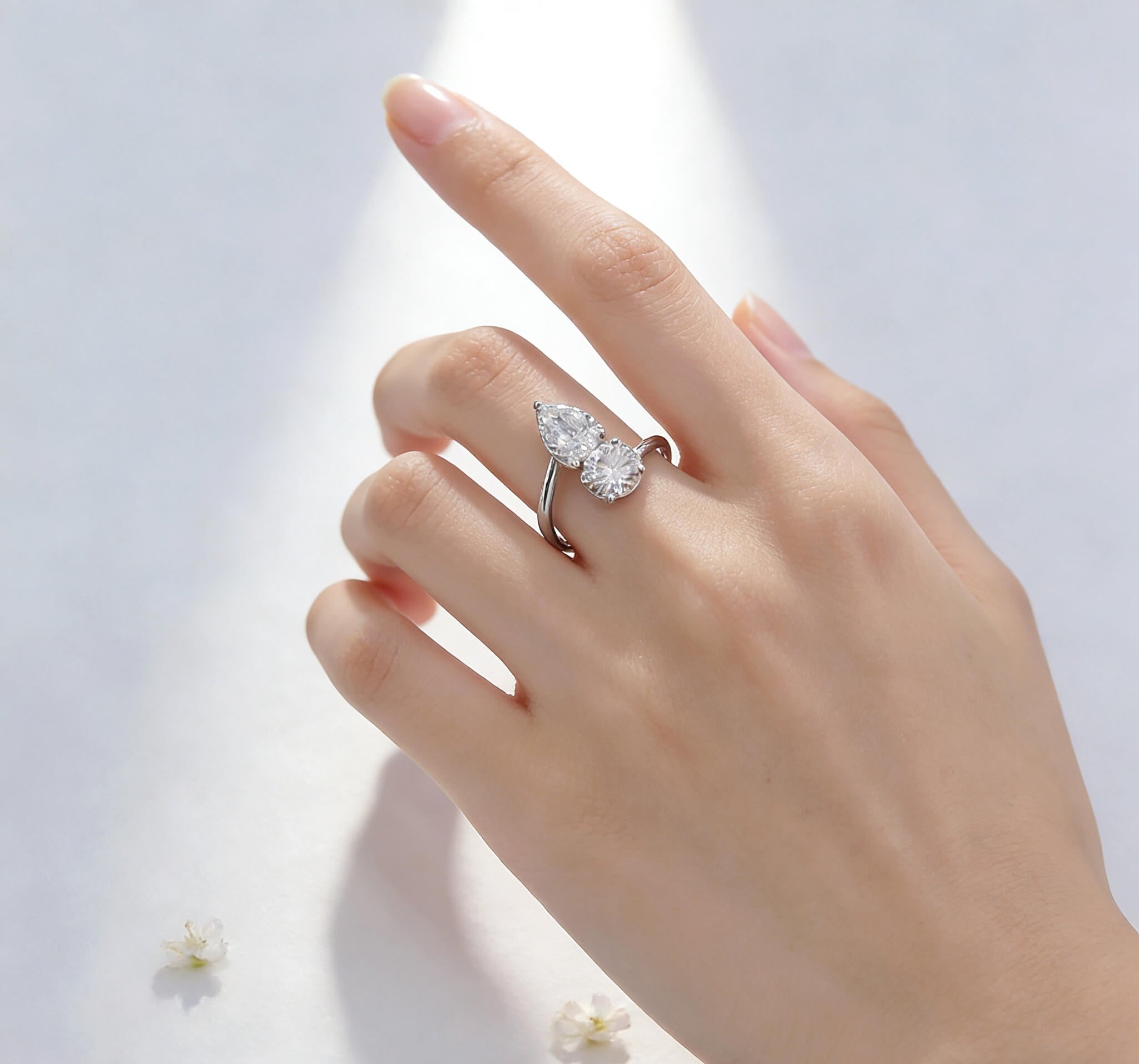 Round and pear cut lab grown diamond engagement ring