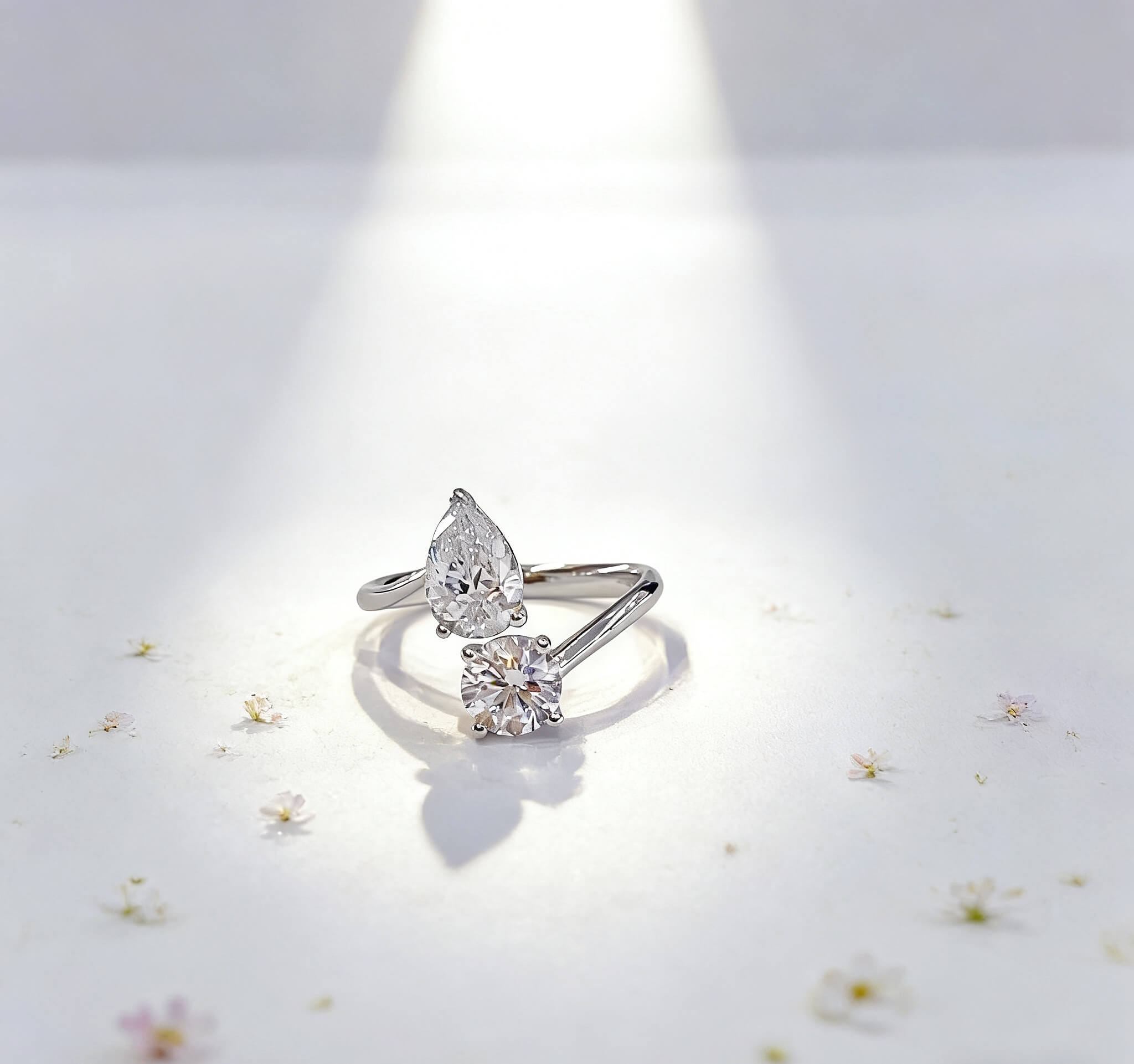 Round and pear cut lab grown diamond engagement ring