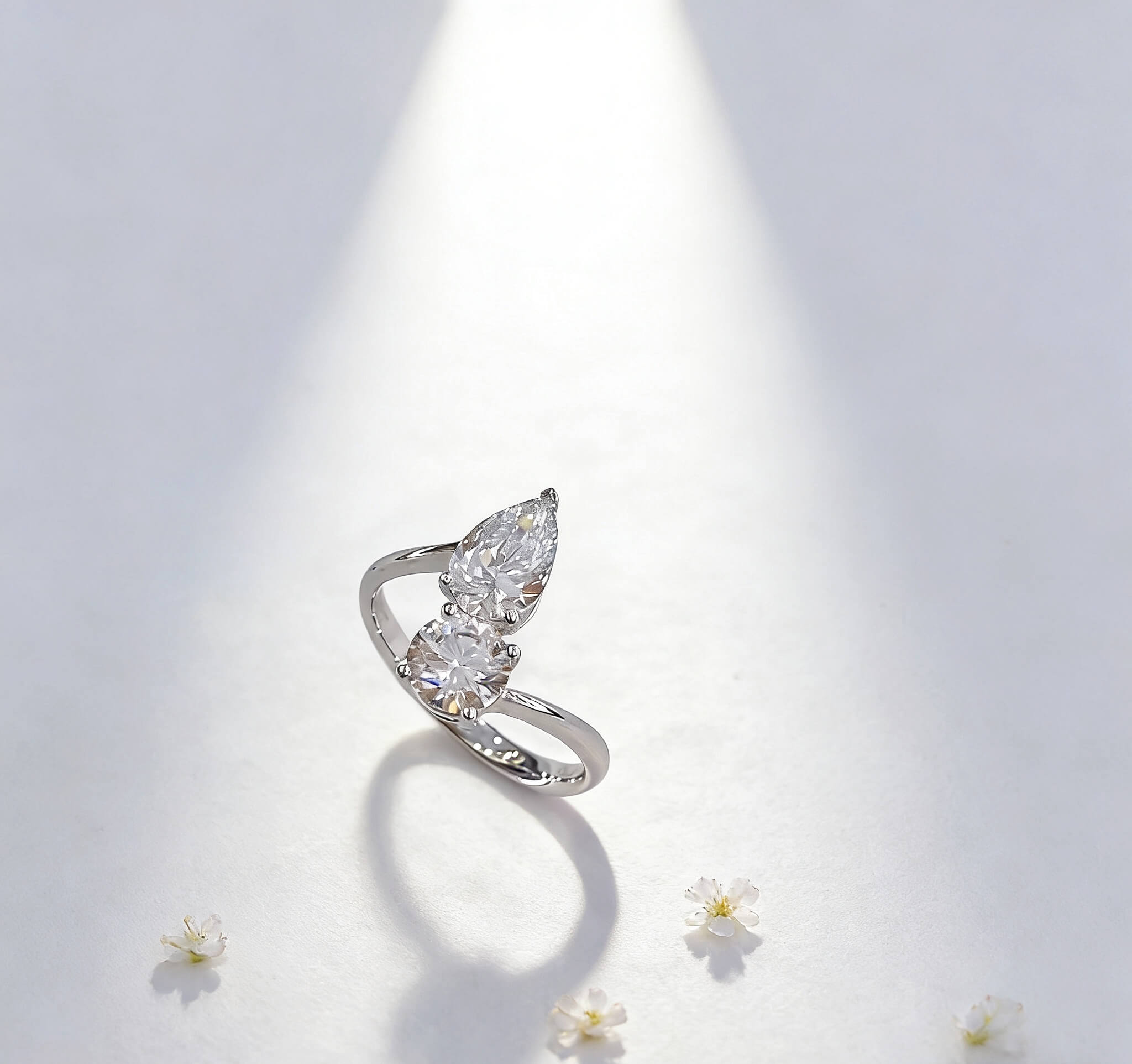 Round and pear cut lab grown diamond engagement ring