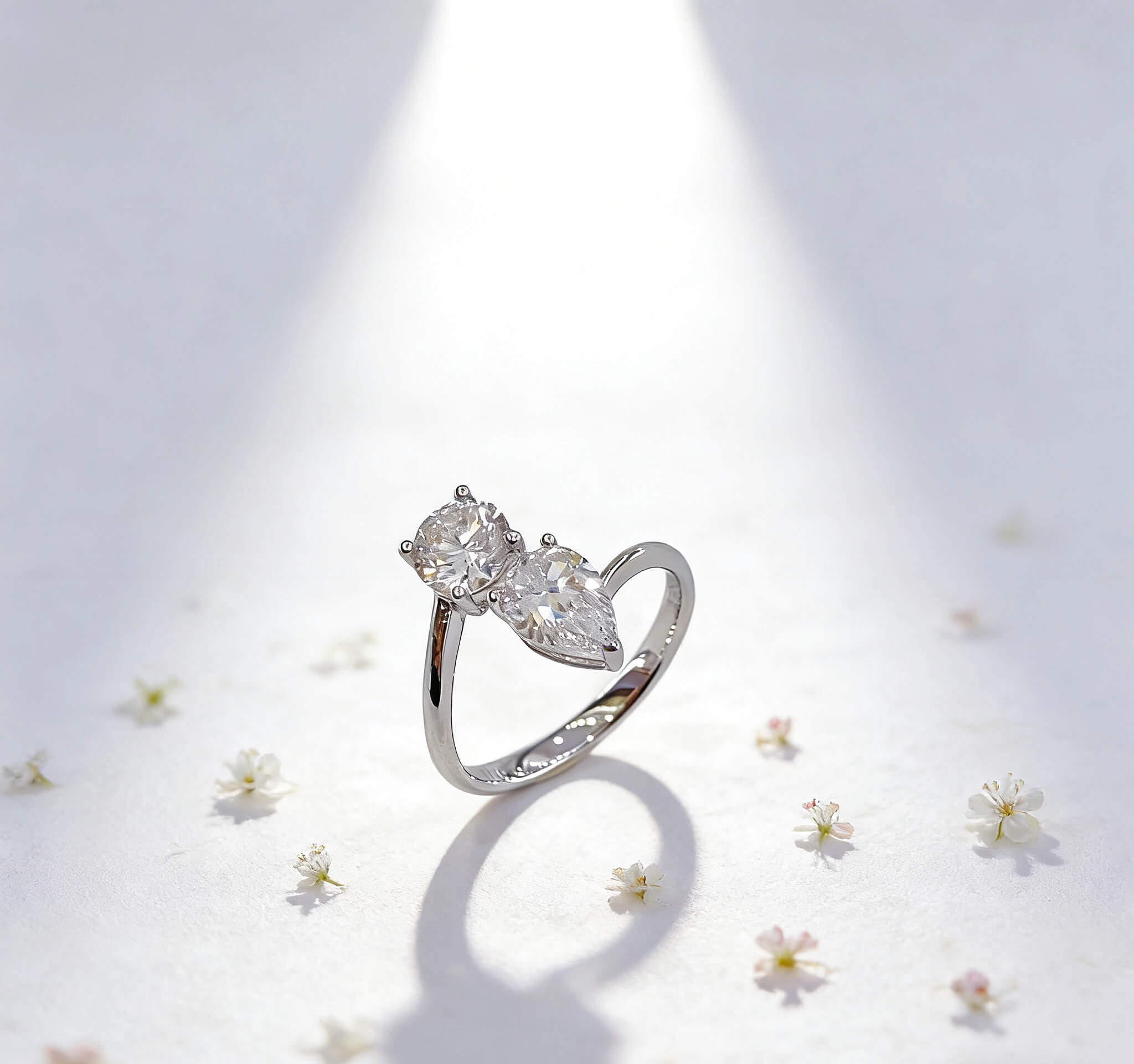 Round and pear cut lab grown diamond engagement ring